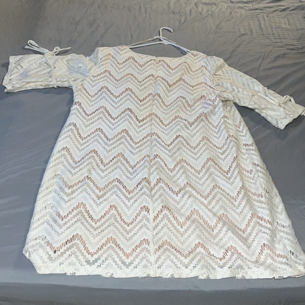 Knee length cream lace dress with bows on the sleeves, with back zipper.